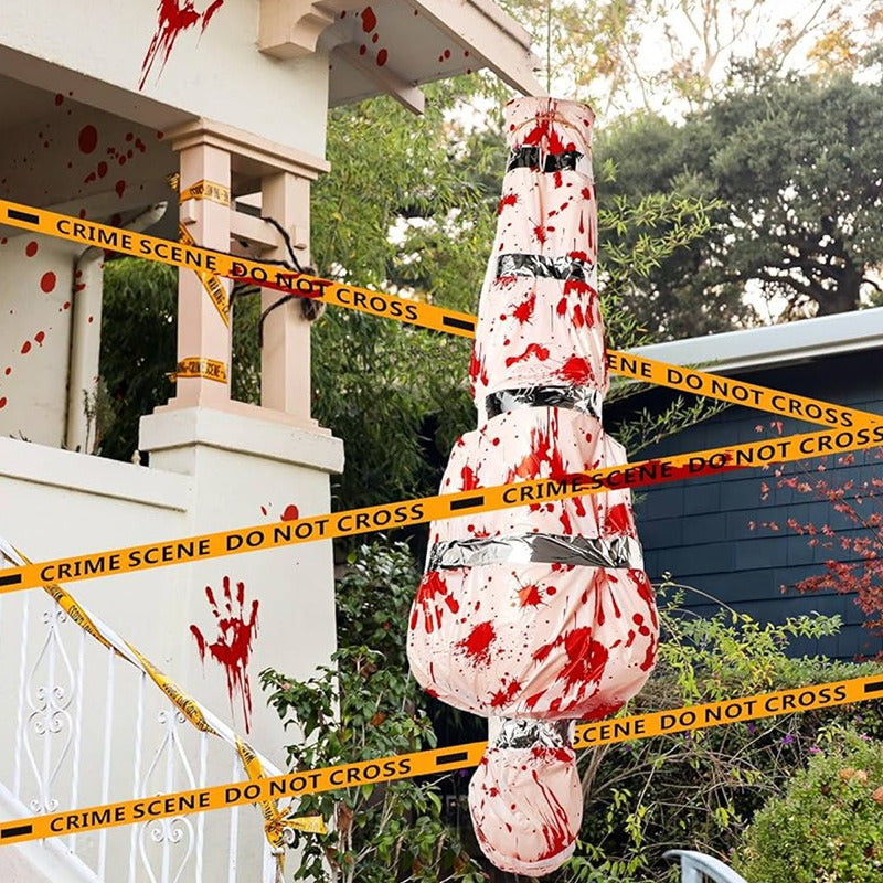 Bloody hanging corpse Halloween decoration suspended outside a house