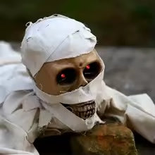 Crawling mummy scary face with glowing red LED eyes