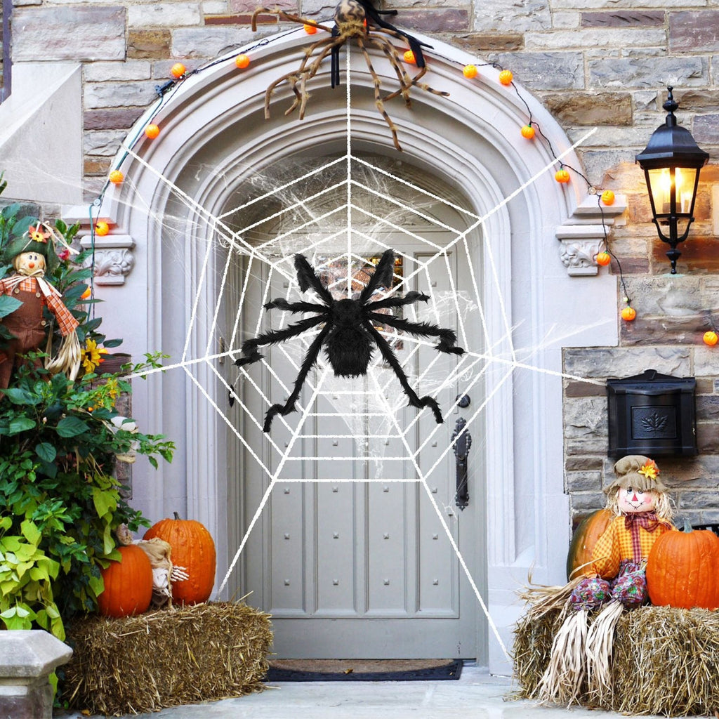 Giant black Halloween spider and white web decorating a front entrance