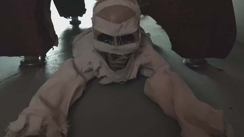 Crawling mummy animated Halloween prop with red LED eyes in motion