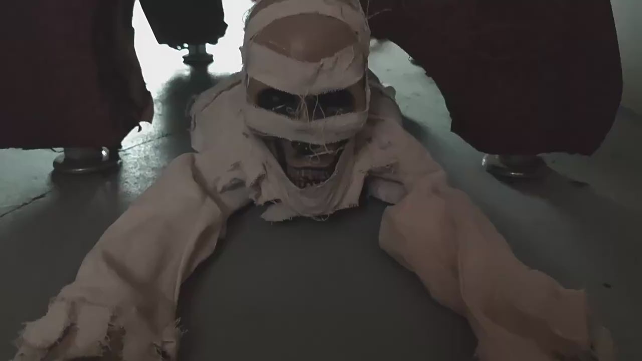 Crawling mummy animated Halloween prop with red LED eyes in motion